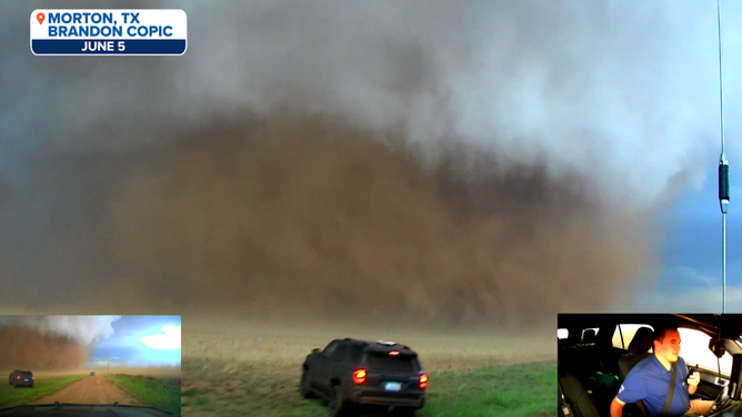Copic and other trackers watch the tornado blast through a field.