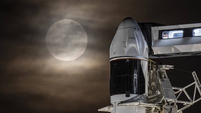 A SpaceX Falcon 9 rocket and Dragon spacecraft with the full Moon in Florida on June 10, 2025.