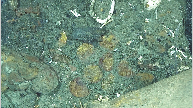High-resolution in situ photograph of cob hoard area in the port section of the stern, showing the obverse and reverse faces of coin, as they were observed on the seabed.