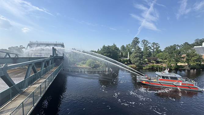 This image shows the Chesapeake Fire Department in Virginia pouring water on a bridge that became stuck in extreme heat on June 24, 2025.