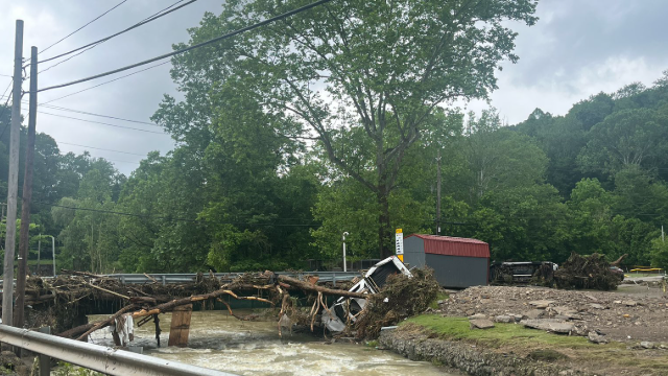 Flooded river crossing in Valley Grove, West Virginia after torrential rain prompted a flash flood emergency Sunday, June 15, 2025.