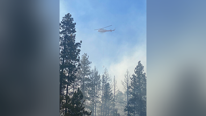 This image shared by the Kittitas County Sheriff's Office in Washington shows a helicopter dropping water on the Red Bridge Fire on June 9, 2025.