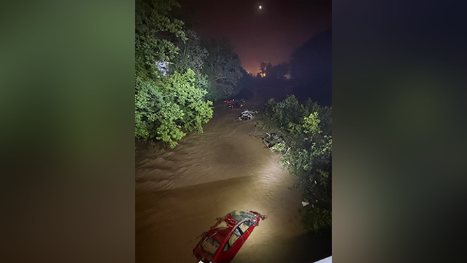 Cars are seen submerged in water after dangerous flash flooding in Wheeling, West Virginia, on Saturday, June 14, 2025.