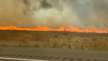 Watch: Couple veers off Idaho interstate as flames from wildfire blow across roadway