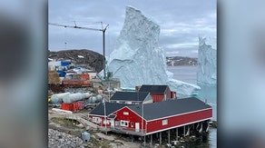 Greenland village comes face-to-face with a giant iceberg