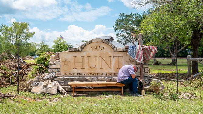 Nathan Sharpe grieves at the entrance to the Hunt city square on July 09, 2025, in Hunt, Texas.