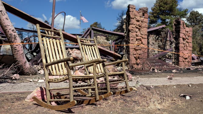 Two rocking chairs that survived the Dragon Bravo Fire when it destroyed Grand Canyon Lodge July 12-13, 2025. The remains of the lodge are visible in the backgound.