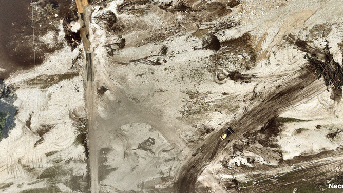 Photo shows that same area, completely devoid of grass and trees following deadly flooding in Ingram.