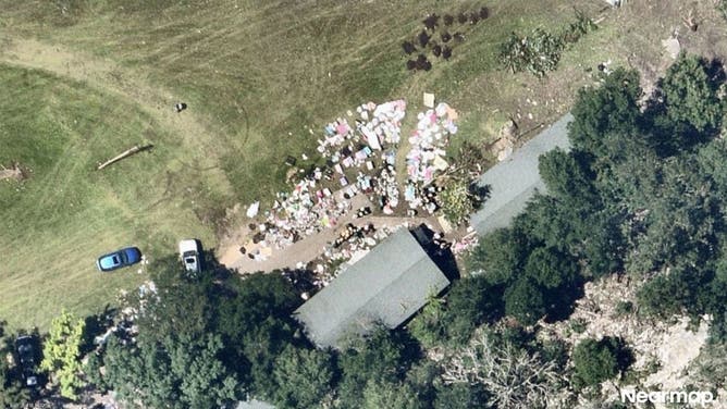 Girls' belonging litter the ground at Camp Mystic after devastating flooding.