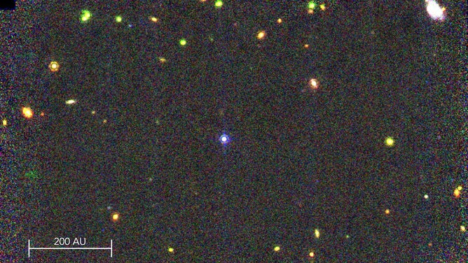 False-color image of WD 0310–688 (bluish-white star in the center) using three James Webb Space Telescope Mid-Infrared Imaging bands. Other lights in the field include distant galaxies, background stars and potential exoplanets.