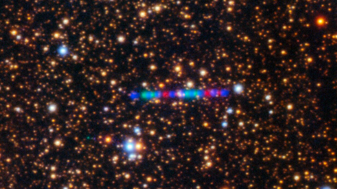 Comet 3I/ATLAS streaks across a dense star field in this image captured by the Gemini North telescope's Gemini Multi-Object Spectrograph (GMOS-N). The left panel captures the comet’s colorful trail as it moves through the Solar System. The image was composed of exposures taken through three filters, shown here as red, green, and blue.