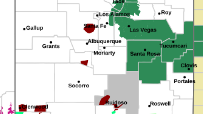 Flash Flood Warning shown in garnet color across New Mexico.