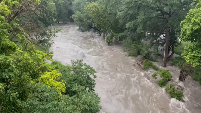 The Guadalupe River quickly floods its banks in Center Point, Texas.