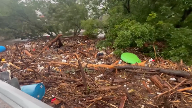 Debris piles up against the bridge in Center Point.