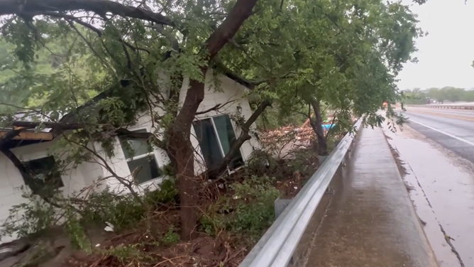 The house comes to a stop next to the bridge in Center Point.