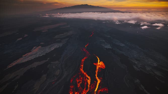 HILO, HI - DECEMBER 7: In an aerial view, lava fissures flow downslope from the north flank of Mauna Loa Volcano on December 7, 2022 in Hilo, Hawaii.