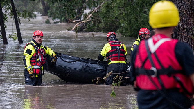 Boerne search and rescue team members prepare their Zodiac boat for operations on the flooded Guadalupe River on July 4, 2025 in Comfort, Texas. Heavy rainfall caused flooding along the Guadalupe River in central Texas with multiple fatalities reported.