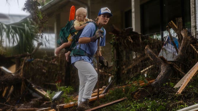 A search and rescue worker looks through debris for any survivors or remains of people swept up in the flash flooding on July 6, 2025 in Hunt, Texas.