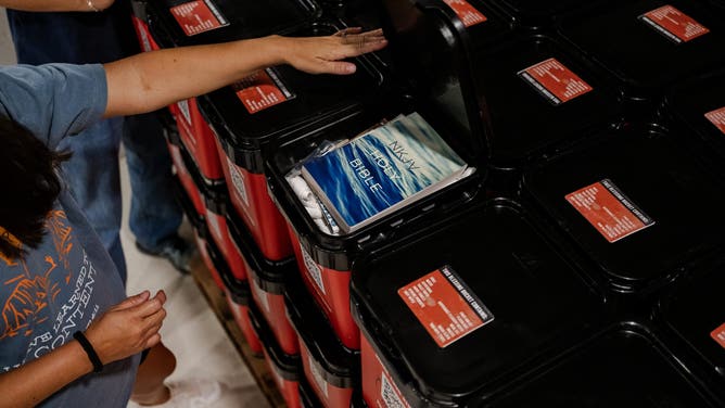Volunteers unload "blessing buckets" that include a bible, water, food and personal hygiene items from a semi-truck full of supplies delivered by Convoy of Hope to Gateway Kerrville Church.
