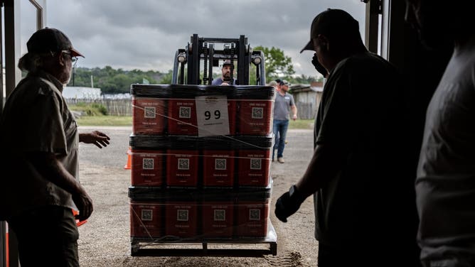 A pallet of "blessing buckets" is brought into Gateway Fellowship Church in Kerrville.