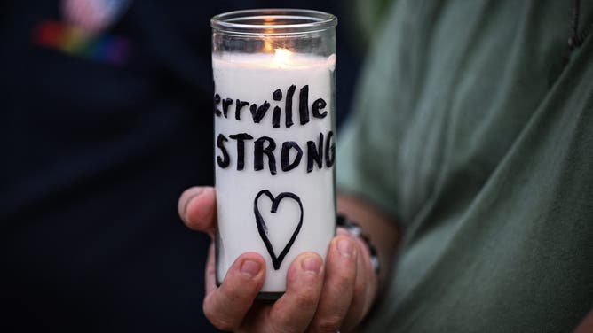 A person holds a candle reading "Kerrville strong" during a vigil for the victims of the floods over Fourth of July weekend, at Travis Park, in San Antonio, Texas, on July 7, 2025. The death toll from catastrophic flooding in Texas rose to more than 100 on July 7, as rescuers continued their grim search for people swept away by torrents of water. Among the dead were at least 27 girls and counselors who were staying at a youth summer camp on a river when disaster struck over the Fourth of July holiday weekend. (Photo by RONALDO SCHEMIDT / AFP) (Photo by RONALDO SCHEMIDT/AFP via Getty Images)