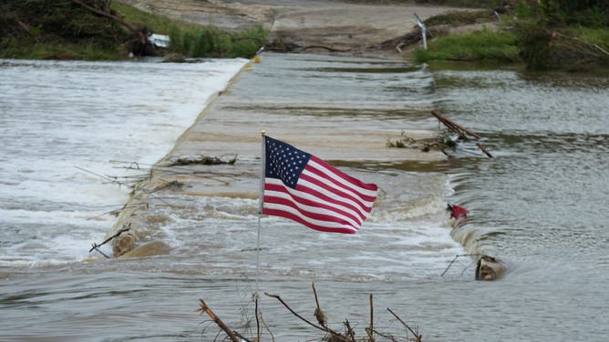 KERR COUNTY, TEXAS, UNITED STATES - JULY 7: A US flag is seen around the Guadalupe River, which overflowed, contributing to a disaster that has killed at least 104 people across the region, including campers and staff in the US state of Texas on Monday, July 7, 2025. (Photo by Lokman Vural Elibol/Anadolu via Getty Images)
