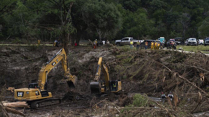 Recovery crews work along the Guadalupe River following the flood in Hunt, Texas, US, on Wednesday, July 9, 2025