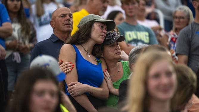 Attendees of a vigil at a high school stadium in Kerrville, Texas, US, on Wednesday, July 9, 2025. Crews in central Texas are digging through massive piles of debris, overturned vehicles and shattered homes for a sixth day as the search continues for victims of flash floods that killed more than 100 people over the Fourth of July weekend.