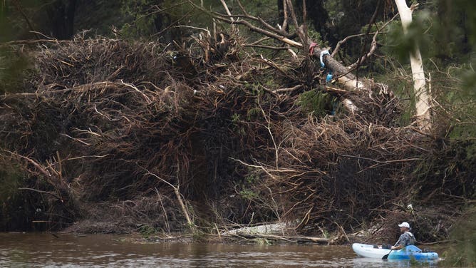 INGRAM, TEAS JULY 5: A man canoes kaiaks along debris in the Guadalupe River after heavy rainfall in Central Teas, Saturday, July 5, 2025. (Jason Fochtman/Houston Chronicle via Getty Images)