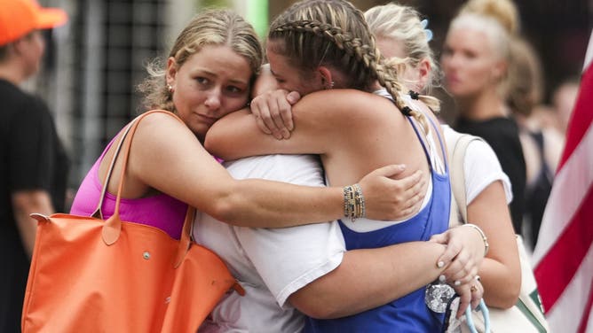 INGRAM, TEXAS JULY 5: Campers embrace after arriving to a reunification area as girls from Camp Waldemar, near the North fork of the Guadalupe River, are reconnected with their families after heavy rainfall in Central Texas, Saturday, July 5, 2025. (Jason Fochtman/Houston Chronicle via Getty Images)