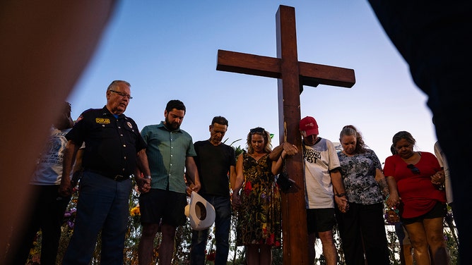 People gather at a memorial for victims of the Kerr County flood in Kerrville, Texas, on Thursday, July 10, 2025.