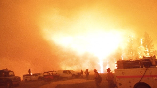 In this handout image provided by Grand Canyon National Park, Firefighters and emergency vehicles are positioned in front of the Dragon Bravo Fire, with intense flames and thick smoke at Grand Canyon National Park on July 10, 2025.