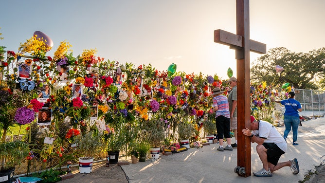 Community residents grieve and pay their respects at a memorial on July 10, 2025 in Kerrville, Texas.