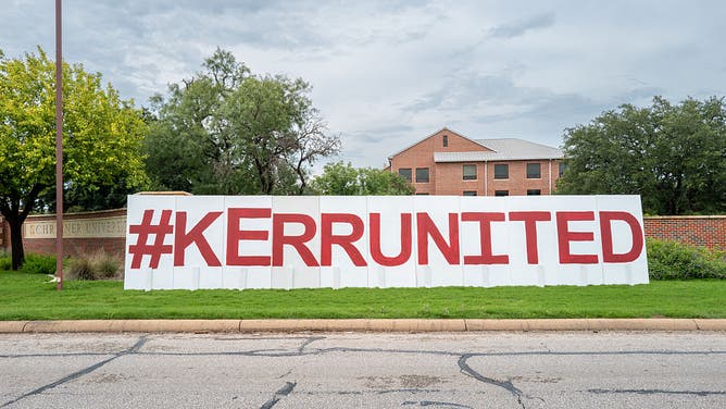 A makeshift sign is displayed at the entrance of Schreiner University on July 14, 2025 in Kerrville, Texas. More than 160 people are still missing after storm cells halted over the area, dumping nearly 15 inches of rain and causing a 22-foot rise along the Guadalupe River.
