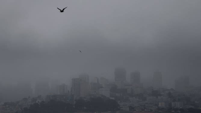 SAN FRANCISCO, CALIFORNIA - JULY 21: Fog hangs over the San Francisco skyline on July 21, 2025 in San Francisco, California. As summer temperatures soar to record highs across much of the U.S., San Francisco is experiencing a very mild summer as a persistent marine layer hangs over the city on most days, keeping daily temperatures in the 50s and 60s. Since May, the city has only once reached a daytime high temperature of 70 degrees. 