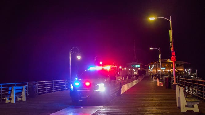 A police officer drives at Santa Monica Pier while warning the public about the regular closure time of the pier amid a tsunami warning in Santa Monica, California, on July 29, 2025. Tsunamis hit parts of Russia's Far East and Japan on July 30 after a huge magnitude 8.8 earthquake, with warnings in place around the Pacific of waves of over three metres (10 feet) in places. (Photo by Apu GOMES / AFP) (Photo by APU GOMES/AFP via Getty Images)
