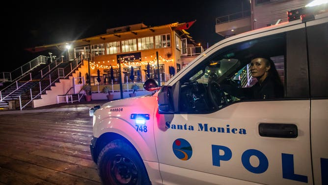 A police officer drives at Santa Monica Pier while warning the public about the regular closure time of the pier amid a tsunami warning in Santa Monica, California, on July 29, 2025. Tsunamis hit parts of Russia's Far East and Japan on July 30 after a huge magnitude 8.8 earthquake, with warnings in place around the Pacific of waves of over three metres (10 feet) in places. (Photo by Apu GOMES / AFP) (Photo by APU GOMES/AFP via Getty Images)