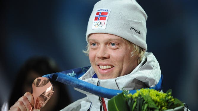 Norway's bronze winner Audun Groenvold celebrates on the podium during the medal ceremony of the men's freestyle ski cross final of the Vancouver Winter Olympics, on February 21, 2010.