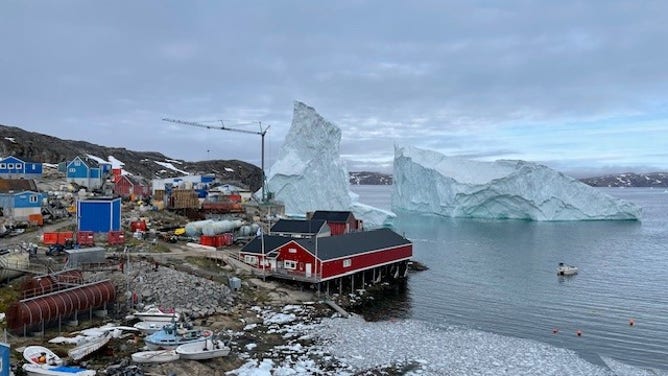 Greenland village comes face-to-face with a giant iceberg