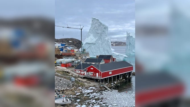 Greenland village comes face-to-face with a giant iceberg