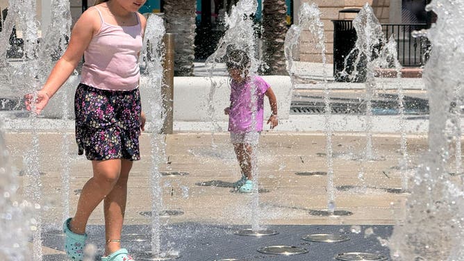 Children play in the water at a splash pad in West Palm Beach, Florida on July 29, 2025.