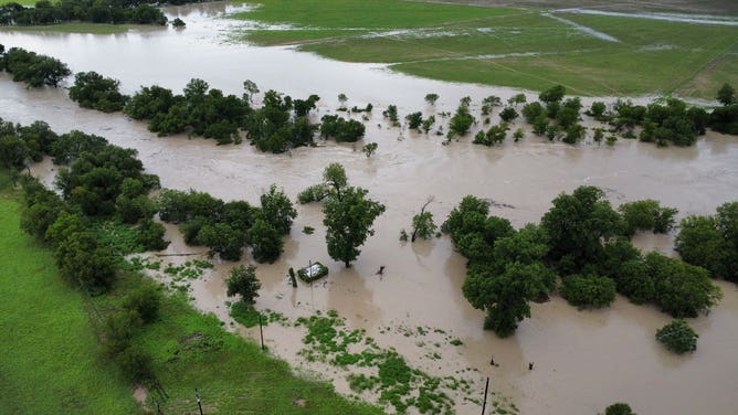 Aerial images show flooding from the Lampass River in Kempner, Texas, covering roads and flooding structures on Sunday, July 13. The river rose over 30 feet in a few hours on Sunday, reaching just below 33 feet, major flood stage.