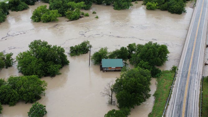 Aerial images show flooding from the Lampass River in Kempner, Texas, covering roads and flooding structures on Sunday, July 13. The river rose over 30 feet in a few hours on Sunday, reaching just below 33 feet, major flood stage.