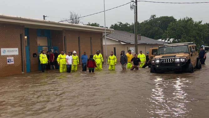 First responders in flood water near the Sequoyah Boys and Girls Club in Sallisaw, Oklahoma on July 8, 2025.