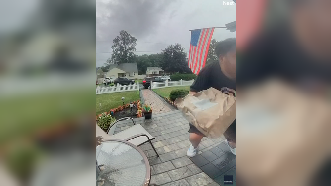 Delivery driver crouches down after nearly being hit by lightning.