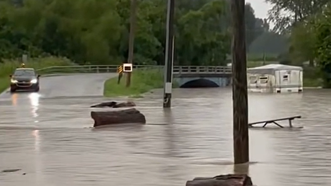 Camper floats toward a bridge in New Pekin, Indiana, during bad flooding.