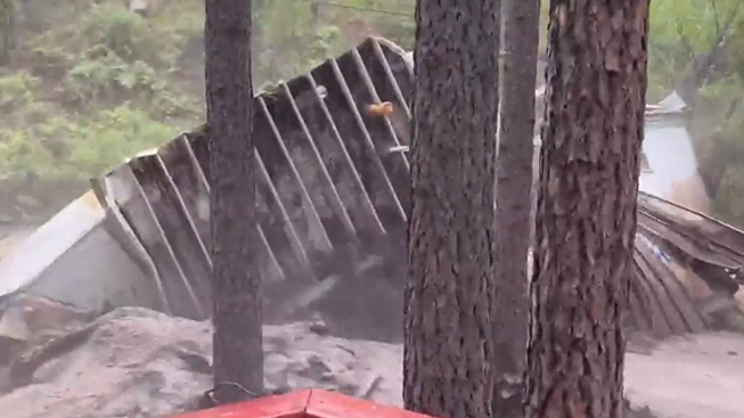 The home starts to break apart in the flooding.
