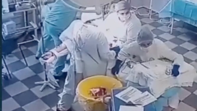 Doctors brace their patient while a 8.8 magnitude earthquake rocks the surgery center in Russia on July 30, 2025.