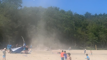 Dust devil wreaks havoc on New York beach as children run screaming for cover