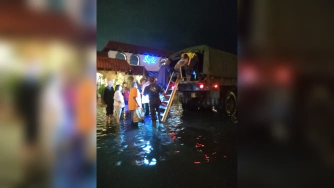 Patrons taken from flooded restaurants by high-water trucks in Margate, New Jersey, Thursday evening.